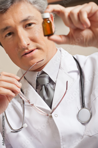 Photo: Doctor Holding Medicine Bottle Doctor Holding Medicine Bottle