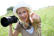 Portrait of adventure girl using photo camera in nature