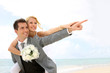 Honeymoon piggyback ride on the beach