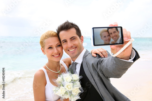 Photo: Bride and groom taking picture of themselves Bride and groom taking picture of themselves