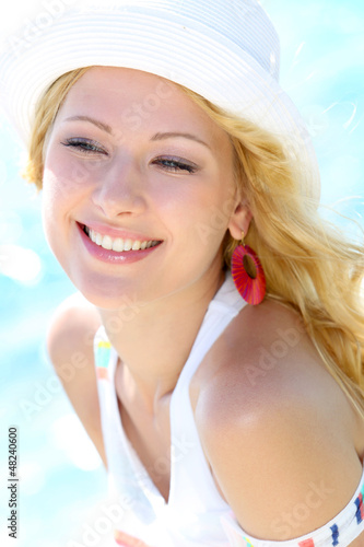 Photo: Closeup of beautiful girl at the beach Closeup of beautiful girl at the beach