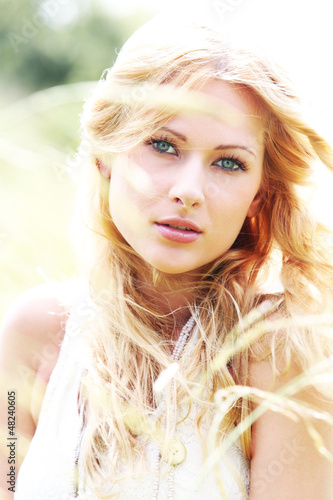 Photo: Beautiful blond girl in meadow Beautiful blond girl in meadow