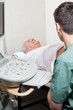 Senior male abdomen ultrasound in clinic