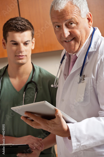 Photo: Senior Doctor Holding Clipboard Senior Doctor Holding Clipboard