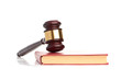 Judge's gavel on red legal book