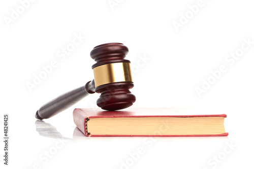 Photo: Judge's gavel on red legal book Judge's gavel on red legal book