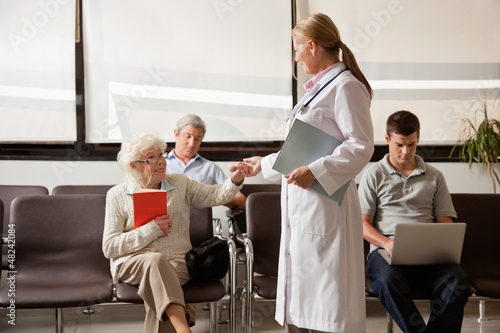 Photo: Doctor Holding Senior Woman's Hand Doctor Holding Senior Woman's Hand