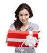 Young woman reaches out a gift wrapped in red paper