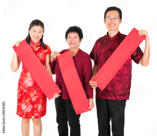 Photo: Asian Chinese family holding red spring couplets Asian Chinese family holding red spring couplets