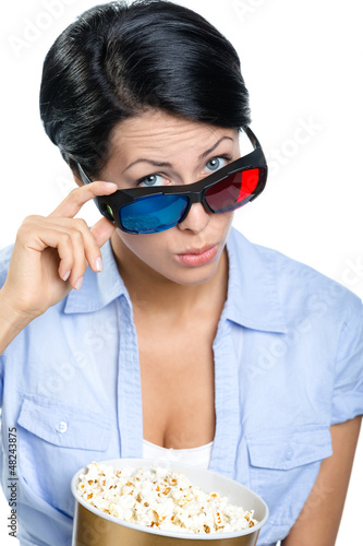 Photo: Girl in 3D spectacles watching movie with popcorn Girl in 3D spectacles watching movie with popcorn