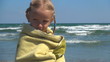 Child Trembling in a Towel after Bathing in the Sea