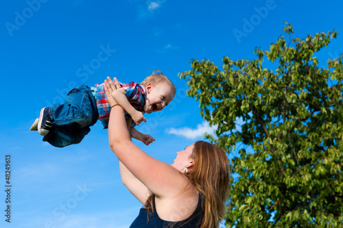 Photo: Family - mother and child playing in garden Family - mother and child playing in garden
