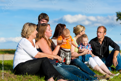Photo: Family and multi-generation - fun on meadow in summer Family and multi-generation - fun on meadow in summer