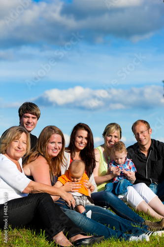 Photo: Family and multi-generation - fun on meadow in summer Family and multi-generation - fun on meadow in summer