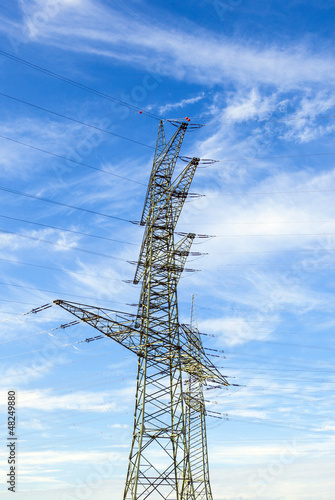 Photo: electrical tower in landscape with street electrical tower in landscape with street