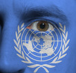 face with the United Nations flag painted on it