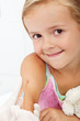 Smiling child receiving vaccine