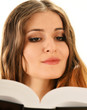 Young woman reading a book isolated on white