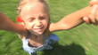 Mother Spinning her Little Girl, Kid Smiling at Camera