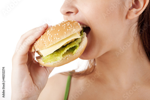 Photo: Young attractive woman eating hamburger Young attractive woman eating hamburger