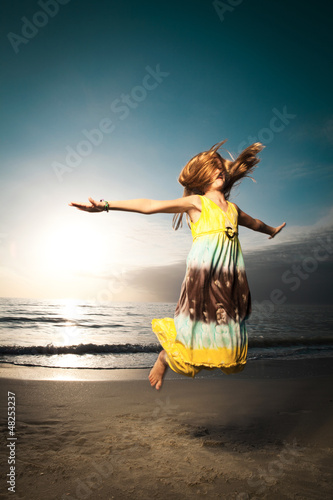 Photo: Girl jumping and dancing on beautiful beach. Girl jumping and dancing on beautiful beach.