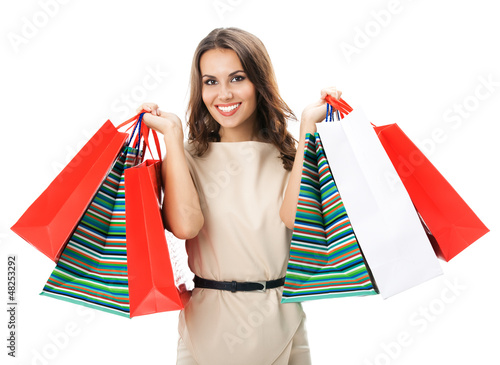 Photo: Young happy woman with shopping bags, isolated Young happy woman with shopping bags, isolated