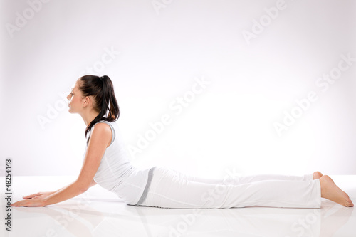 Photo: Young Caucasian woman lying in yoga position Young Caucasian woman lying in yoga position