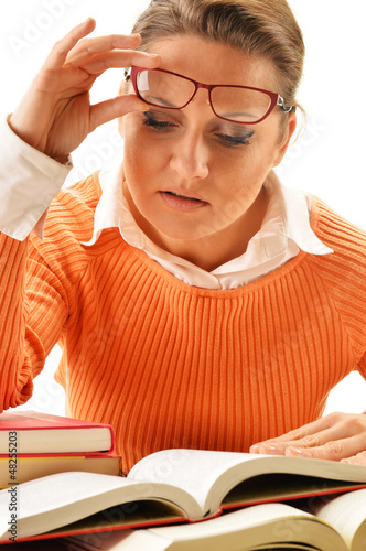 Photo: Young woman reading a book. Female student learning Young woman reading a book. Female student learning