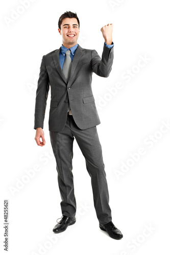 Photo: Businessman raising arms in sign of victory. Businessman raising arms in sign of victory.
