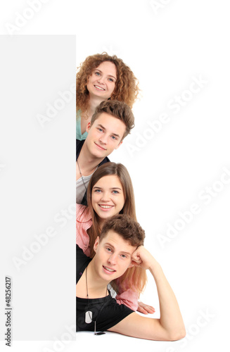 Photo: Happy group of people with a banner - isolated over a white Happy group of people with a banner - isolated over a white