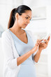 Beautiful Indian woman using mobile phone happy