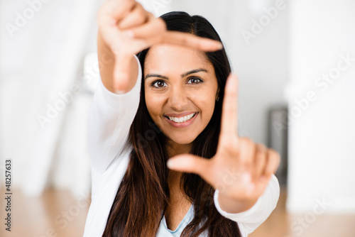 Photo: Beautiful Indian woman framing photograph happy smiling Beautiful Indian woman framing photograph happy smiling