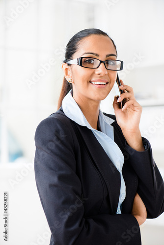 Photo: Indian business woman using mobile phone happy Indian business woman using mobile phone happy