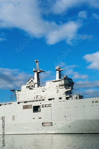 Photo: Military ship detail over blue sky. Military ship detail over blue sky.