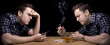 man playing himself in a game of cards