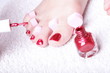 female feet red polished nails