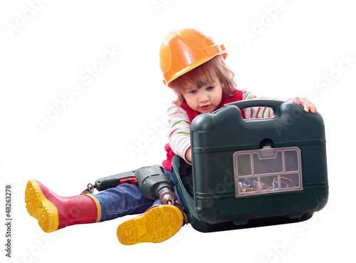 Photo: Child in hardhat with working tools Child in hardhat with working tools