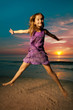 Photo: Girl jumping and dancing on beautiful beach. Girl jumping and dancing on beautiful beach.