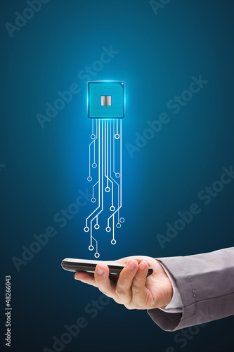 Photo: Microchip with mobile phone Holds in a hand Microchip with mobile phone Holds in a hand