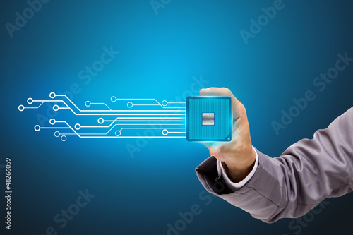 Photo: Holds in a hand a microchip. Holds in a hand a microchip.