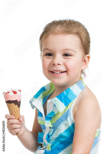 Photo: joyful child girl eating ice cream in studio isolated joyful child girl eating ice cream in studio isolated