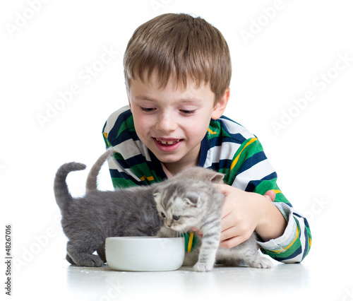 Photo: funny child feeding attractive kitten funny child feeding attractive kitten