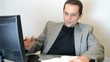 businessman at the computer to write in the diary