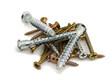 A handful of construction screws of different lengths on white b