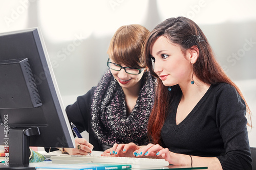 Photo: two schoolgirls doing homework two schoolgirls doing homework