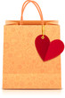 Ornate paper shopping bag with heart label on golden ribbon