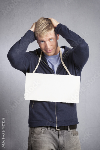 Photo: Desperate man showing white empty signboard. Desperate man showing white empty signboard.