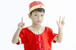 China boy in traditional Chinese red Tang suit greeting