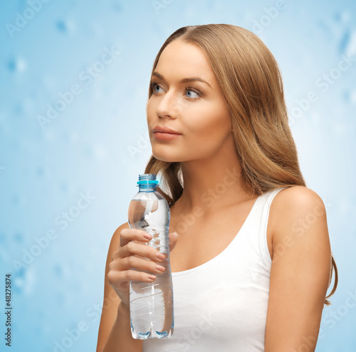 Photo: young beautiful woman with bottle of water young beautiful woman with bottle of water