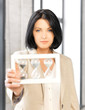 pensive businesswoman with sand glass